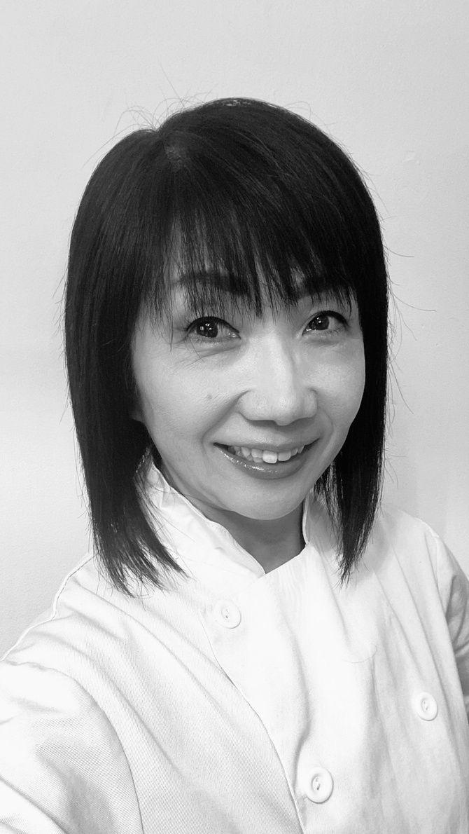 Chef Takako smiling, wearing chef's whites
